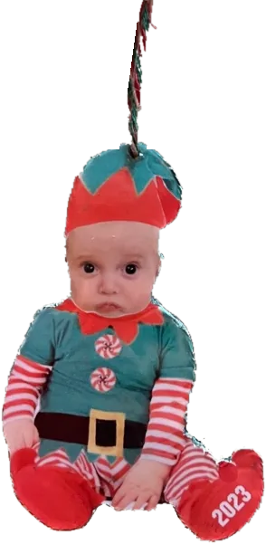 A hanging photo ornament of an elf with a child's face, dated on one boot.