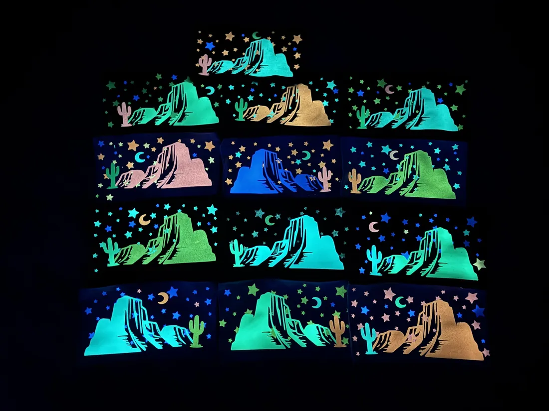 A set of matching glow-in-the-dark desert canyon prints laid out in a grid, glowing in the dark.